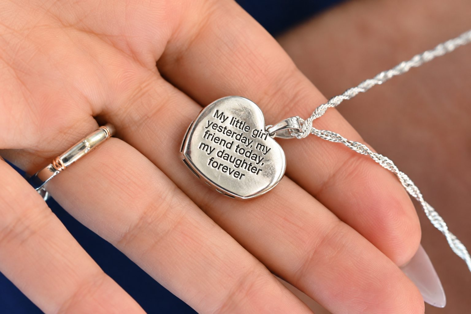 Close-up of an engraved heart locket necklace